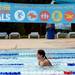A Buhr Park Shark swims under a banner hung over the pool as she participates in a swimathon to raise funds for Ann Arbor Active Against ALS and Bob Schoeni at the Buhr Park Pool on Wednesday morning. Melanie Maxwell | AnnArbor.com